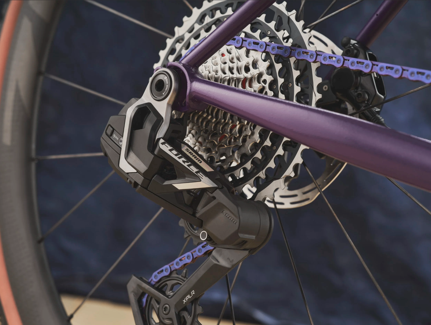 Drivetrain detail: SRAM Force XPLR rear derailleur on the purple frame