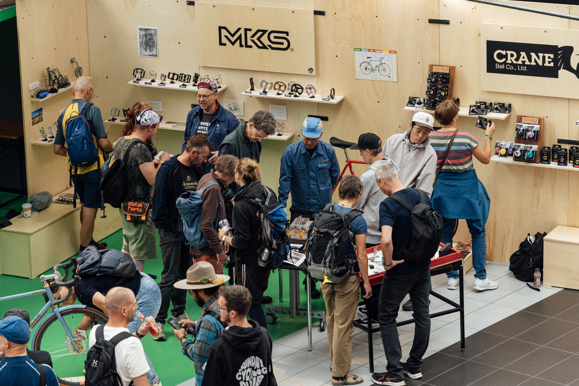 Visitors gathering around the MKS and Crane Bell stand at BESPOKED Dresden 2026