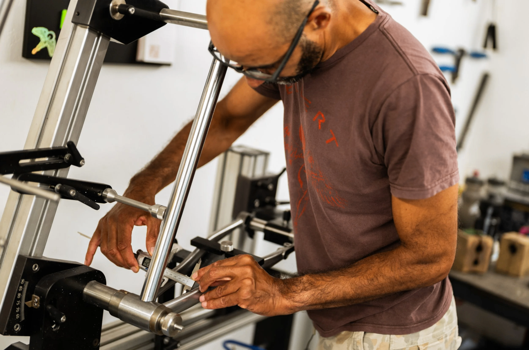 Telbert checking a frame on the alignment jig with digital calipers