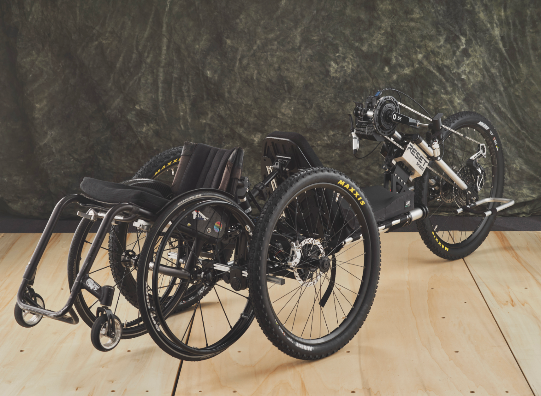 Adaptive handcycle and wheelchair displayed together as part of the 2025 scholarship showcase